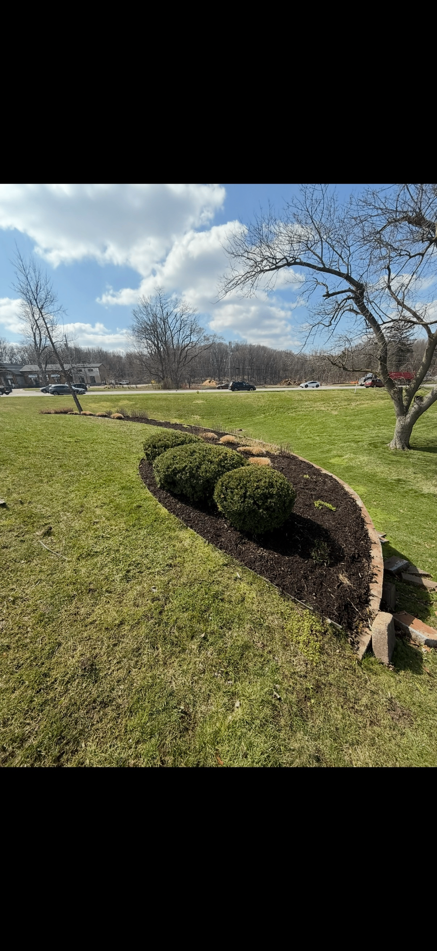 Curved Bed Mulch Install — Mulching project by Crown Scapes in West Michigan